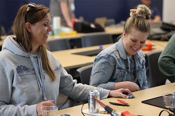 Two high school teachers at a cyber skills camp at DSU.